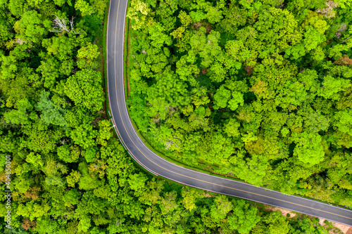Fototapeta Naklejka Na Ścianę i Meble -  Winding road, top view of the corner Look at the beautiful aerial view of asphalt roads, highways through mountains and forests in rainy season. For traveling and driving in nature.