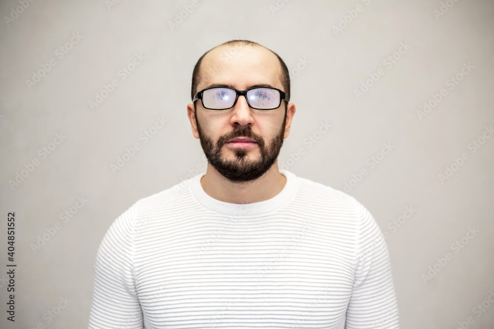 Fototapeta premium Portrait of a serious man with eyeglasses. White background.