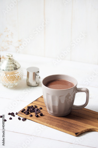 cup of hot chocolate with white wooden background