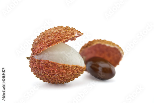 Lychee fruit opened and showing seed on white photo