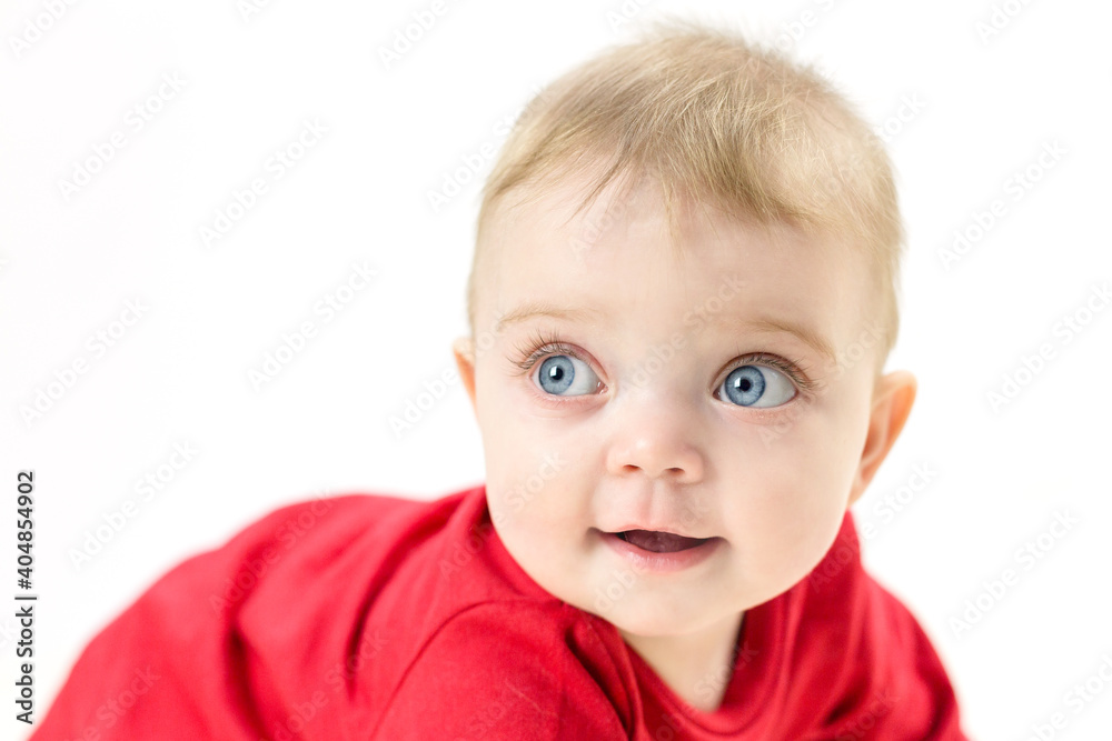 Adorable little girl with huge eyes and long eyelashes on a white background.