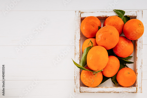 tangerines with leaves on a light background with a place for text 