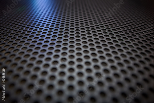 Black grille texture as a background.