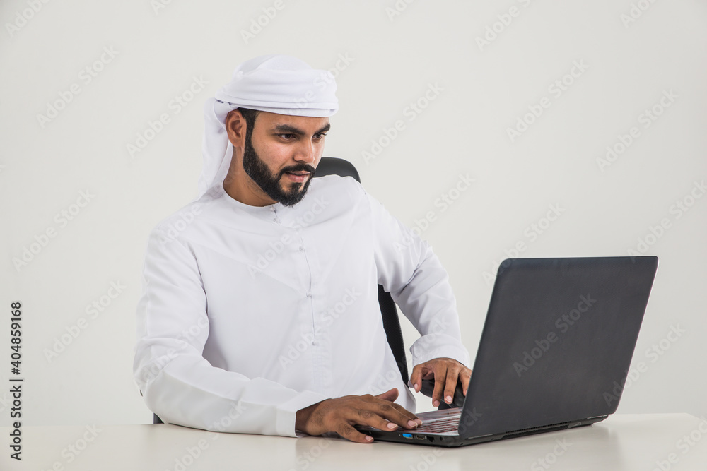 Handsome man with traditional white kandura from uae. Studio portraits with Dubai outfit about fashion and business Handsome man with traditional white kandura from uae. Studio portraits with Dubai outfit about fashion and business