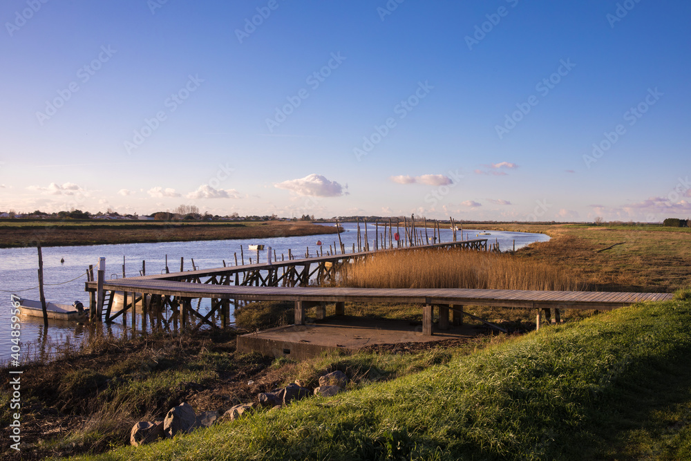 panoramic view over the marshland and the Lay river separating l'Aiguillon sur Mer and La faute sur Mer, Vendee France panoramic view over the marshland and the Lay river separating l'Aiguillon sur Mer and La faute sur Mer, Vendee France
