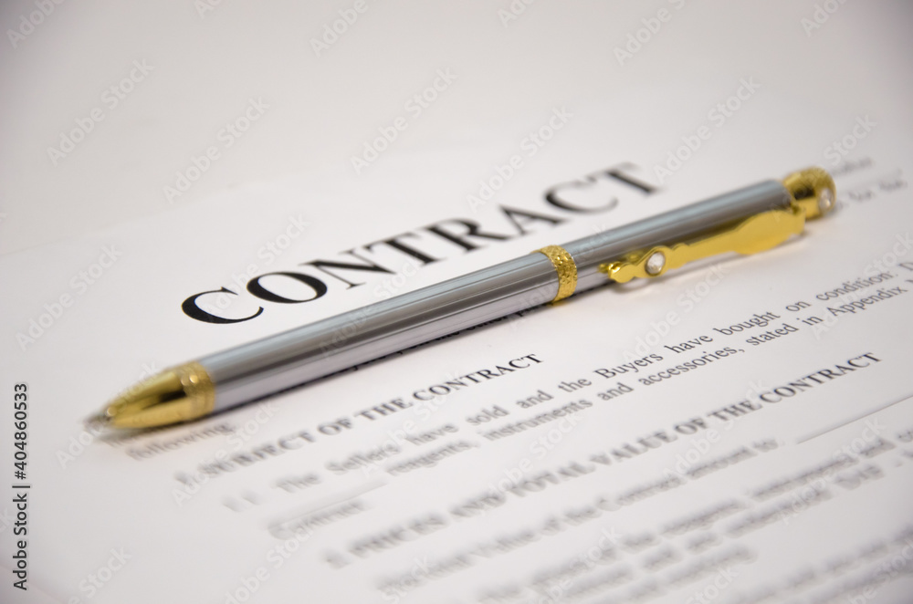 the pen is on the contract and the contract is on a white background the pen is on the contract and the contract is on a white background