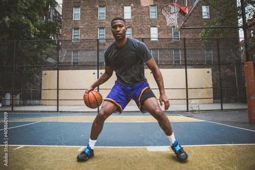 Basketball player training on a court in New york city photo