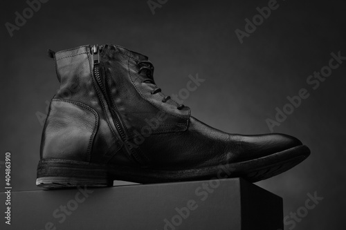 High men's leather boots. Dark background. Fashionable shoes