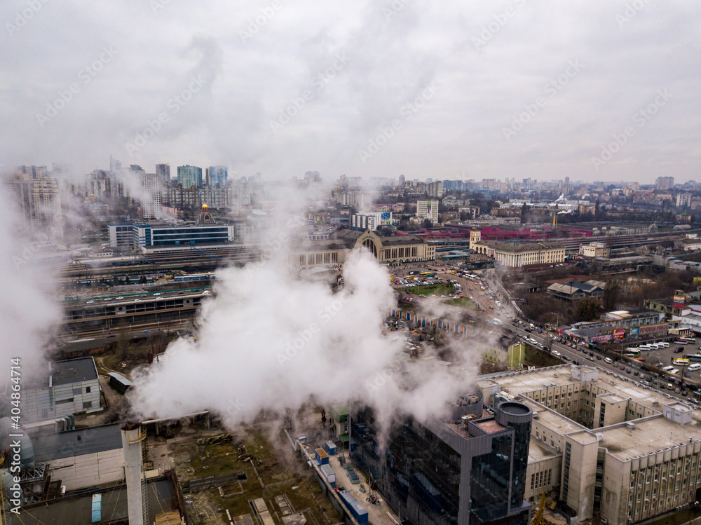 Aerial drone view. The building of the Kiev railway station through the white smoke from the chimneys. Aerial drone view. The building of the Kiev railway station through the white smoke from the chimneys.