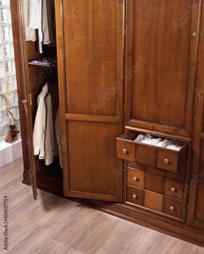 Detail of a wardrobe with doors and drawers open