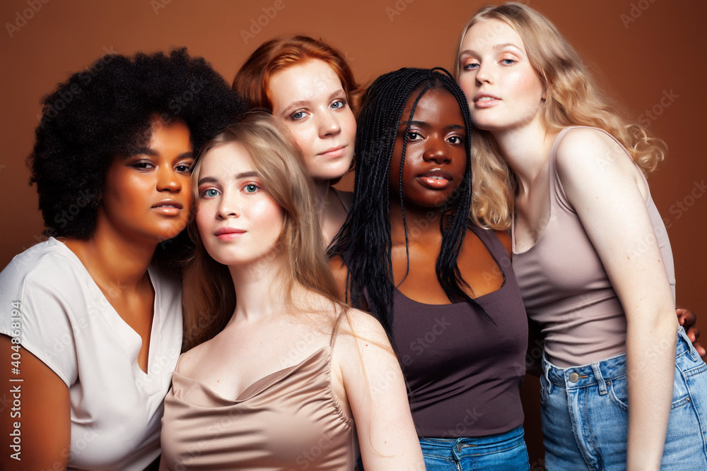 young pretty caucasian, afro, scandinavian woman posing cheerful together on brown background, lifestyle diverse nationality people concept young pretty caucasian, afro, scandinavian woman posing cheerful together on brown background, lifestyle diverse nationality people concept