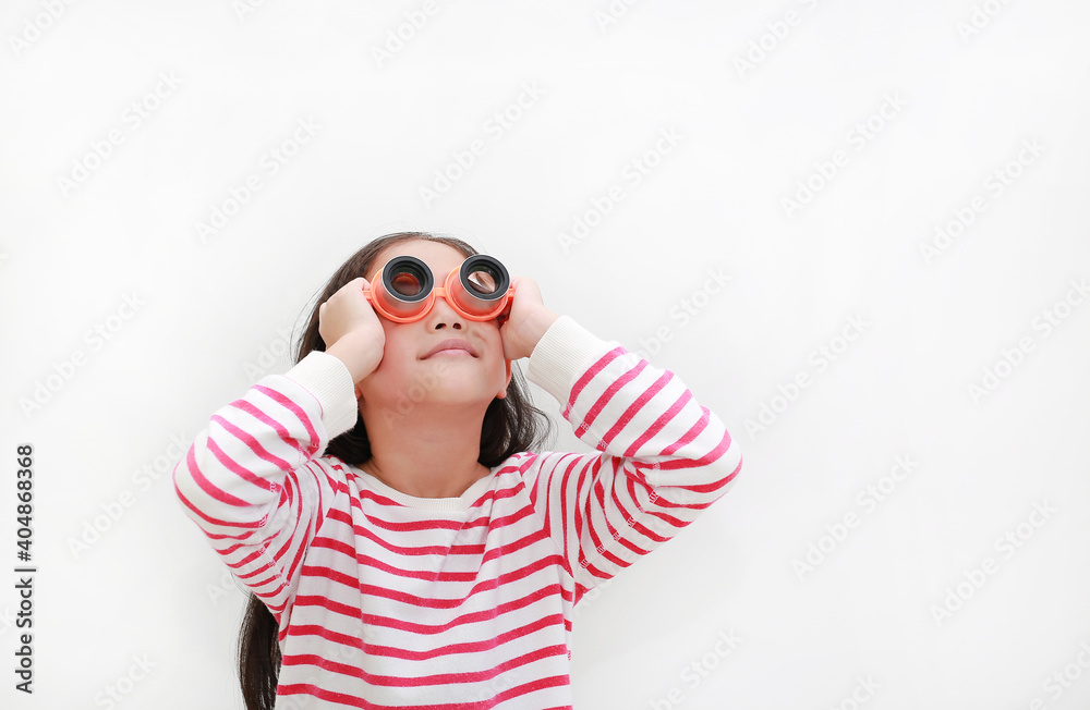 Asian little girl wearing a telescope glasses and looking up over white background isolated. Kid and adventure concept Asian little girl wearing a telescope glasses and looking up over white background isolated. Kid and adventure concept