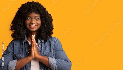 Obraz na plátně Inspired black woman showing clasped hands in pleading gesture