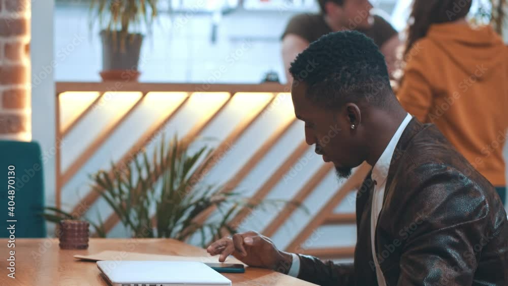African american HR manager meeting with female job applicant using several devices asking questions during business meeting interview. African american HR manager meeting with female job applicant using several devices asking questions during business meeting interview.