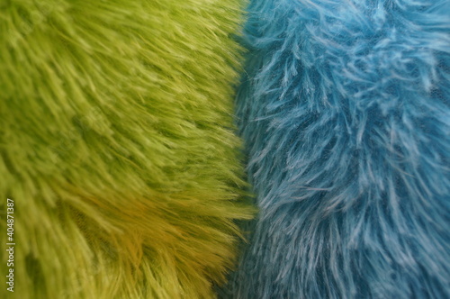 Close-up (macro) of artificial fur of different colors: green and blue. Can be used as a background.