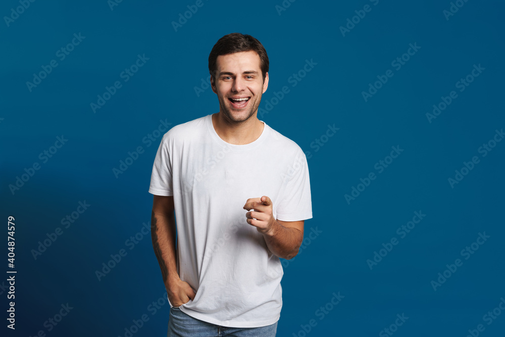 Happy unshaven guy smiling and finger pointing at camera Happy unshaven guy smiling and finger pointing at camera