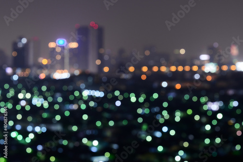 Abstract of colorful bokeh light background with building of bangkok