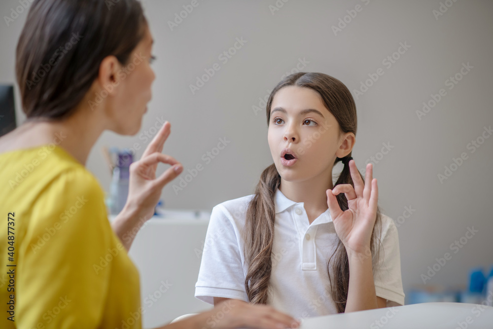 Girl repeating the sound and gesture of psychologist Girl repeating the sound and gesture of psychologist