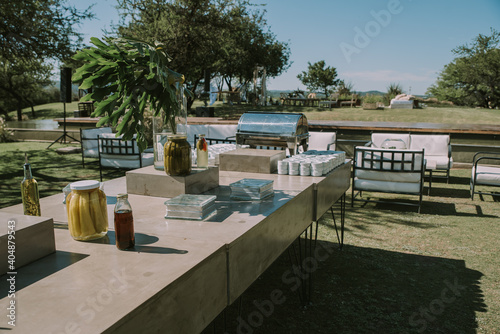 Armchairs and garden table adorned with pots, flowers and imitation leather fabrics. © Juan.paz1