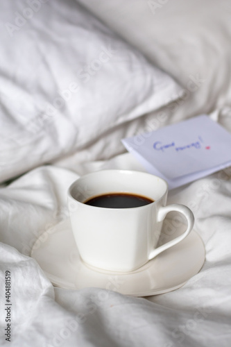 A cup of black coffee in bed