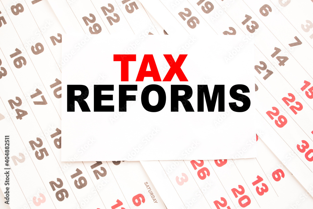 text TAX REFORMS on a sheet from Notepad.a digital background. business concept . business and Finance. text TAX REFORMS on a sheet from Notepad.a digital background. business concept . business and Finance.