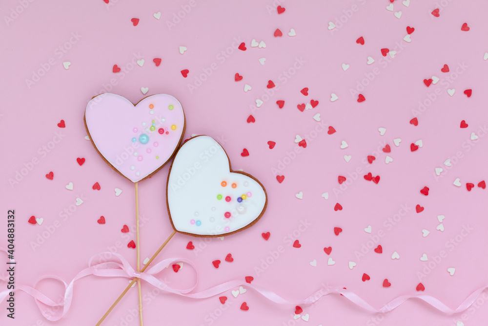 Two pink and white hearts shaped gingerbread for Valentines Day, Mother Day or Birthday on pink background.