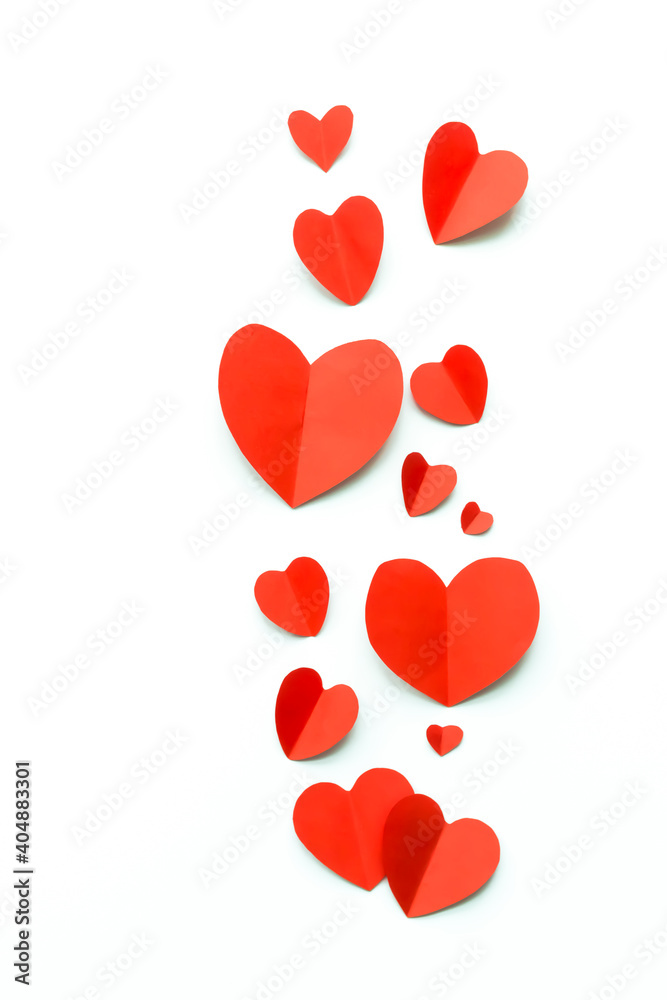 Valentine's Day background. Red paper hearts on a white background. Bright colorful hearts for postcards.