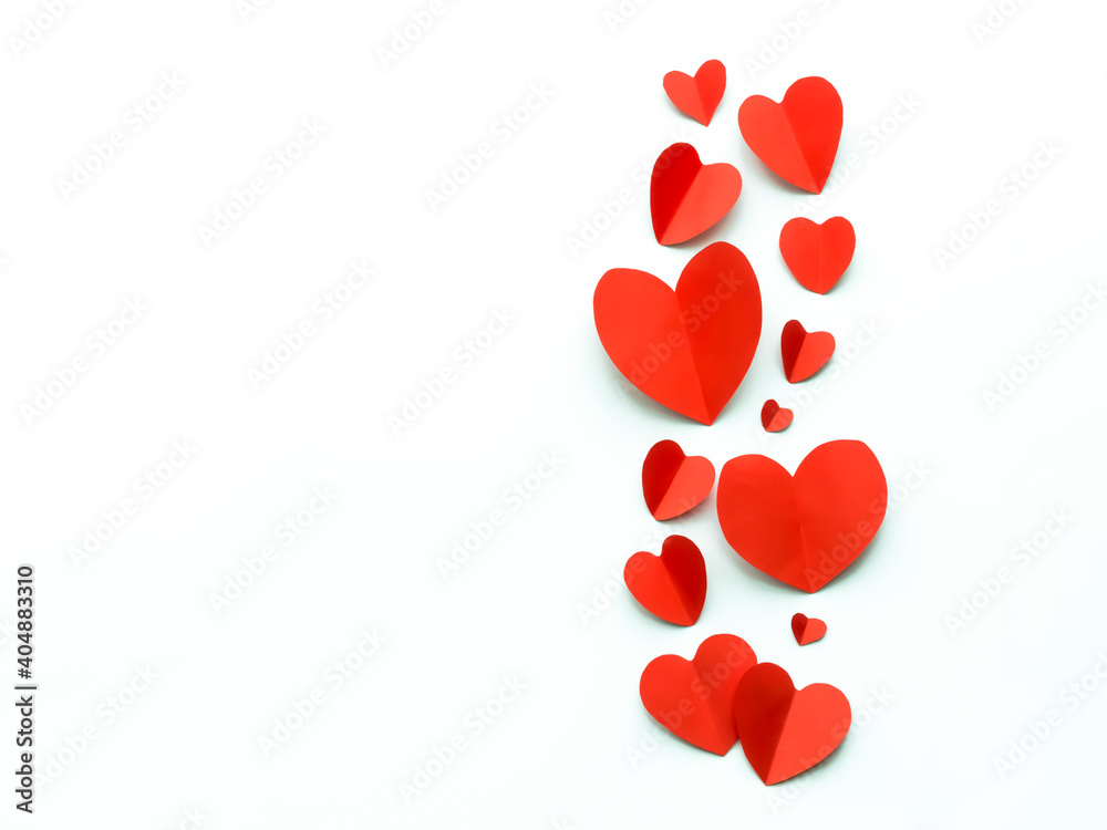 Valentine's Day background. Red paper hearts on a white background. Bright colorful hearts for postcards.