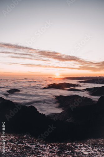 Sunset and sea of clouds on the mountain peak.