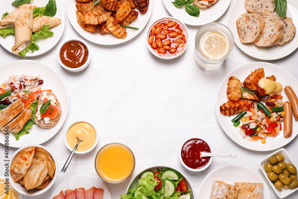 Buffet service. Frame of different dishes on white wooden table, space for text