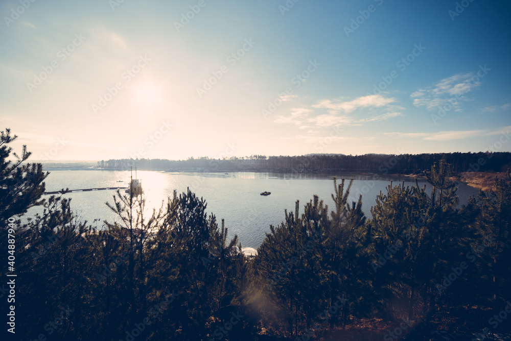 Fototapeta premium Forest lake on a sunny day between the pines