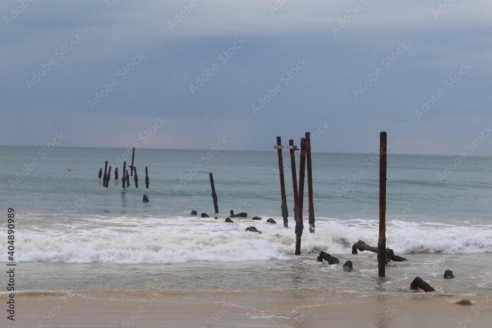 The old wooden bridge and sea wave on the beach background at Khao Pilai, Phangnga, Thailand The old wooden bridge and sea wave on the beach background at Khao Pilai, Phangnga, Thailand