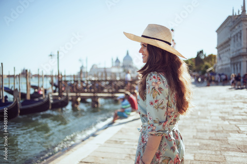 happy young solo traveller woman in floral dress sightseeing © Alliance