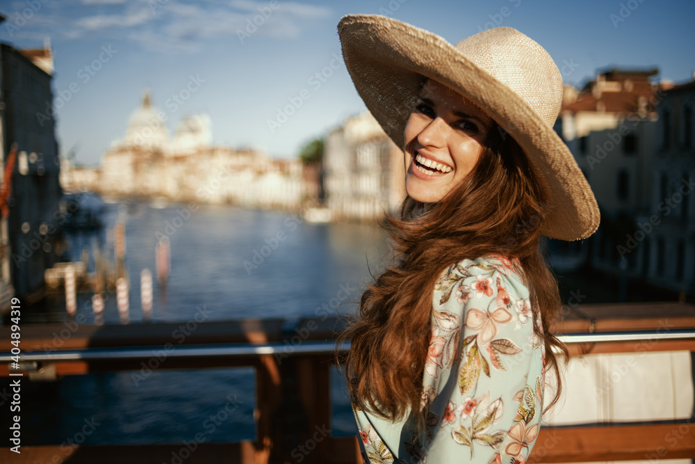 smiling modern traveller woman in floral dress
