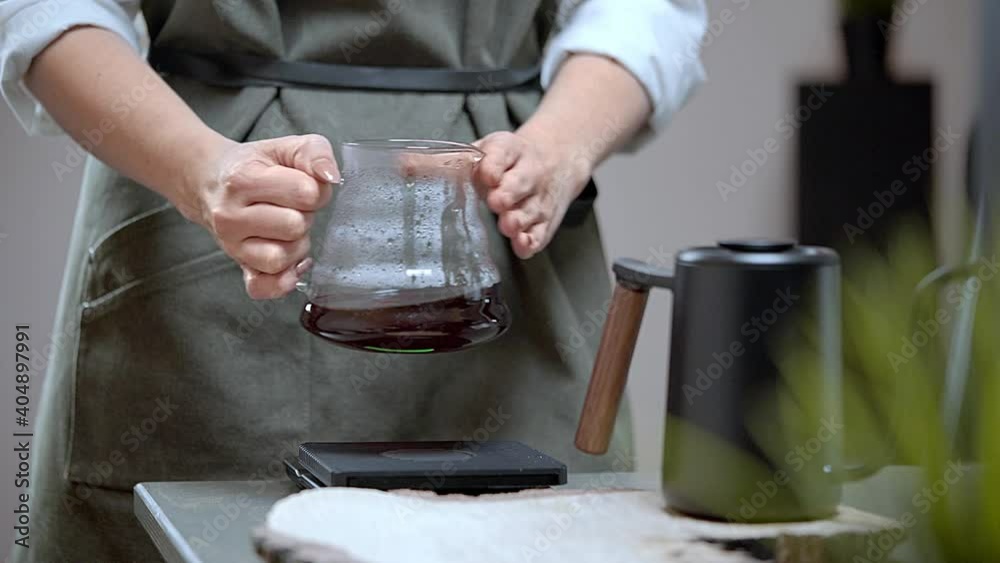 Woman Barista Stirring Prepared Coffee in Jar. Funnel Brewing Alternative Method Woman Barista Stirring Prepared Coffee in Jar. Funnel Brewing Alternative Method