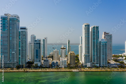 Skyscraper glass and white facades at a bright sunny day on the blue sky background. Economy finances and business activity concept aerial view © ronedya