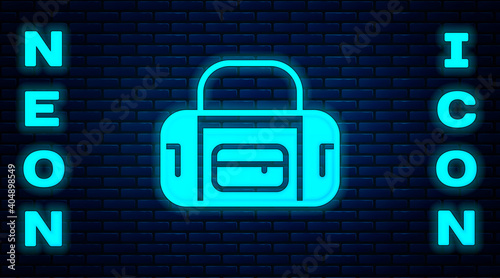 Glowing neon Sport bag icon isolated on brick wall background. Vector.