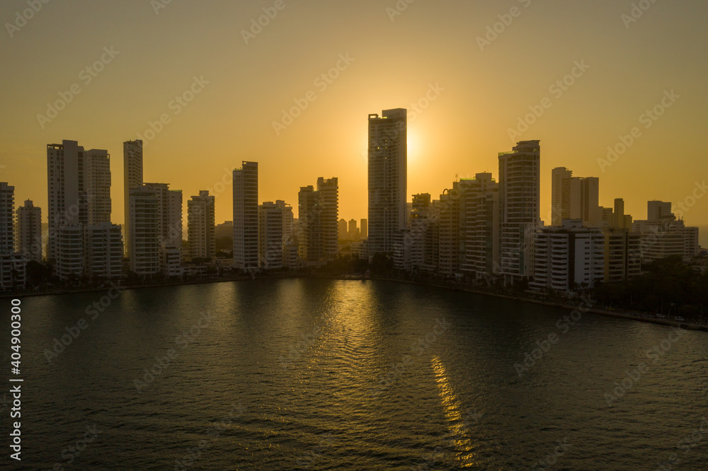 Fototapeta premium Miami Florida sunset with colorful illuminated business and residential buildings aerial view.
