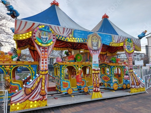 Bright children's carousel steam train in the amusement park.