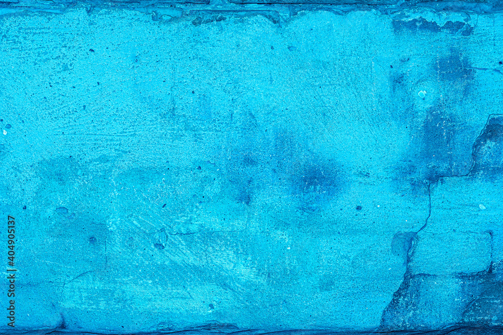 The blue texture of the old brick wall with cracks and flattened plaster. Retro background with text copy space.