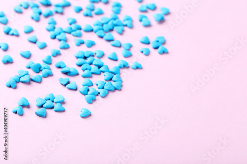 Heart shaped sprinkles on pink background