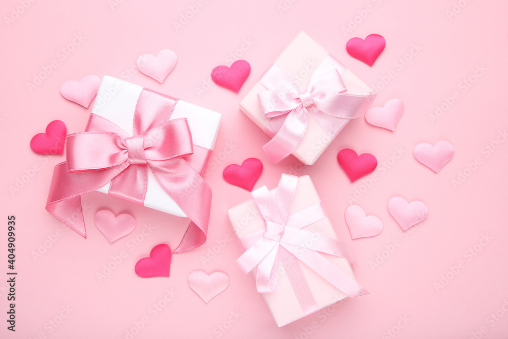 Gift boxes with hearts on pink background