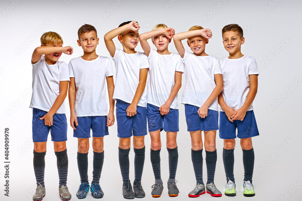 Fototapeta premium teen boys ready to take ball kick on their body, they protect their football goal, close face and lower part of body