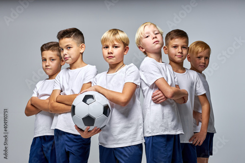 Fototapeta Naklejka Na Ścianę i Meble -  children soccer team isolated in studio, friendly kids sport family leisure lifestyle concept. copy space advertisement