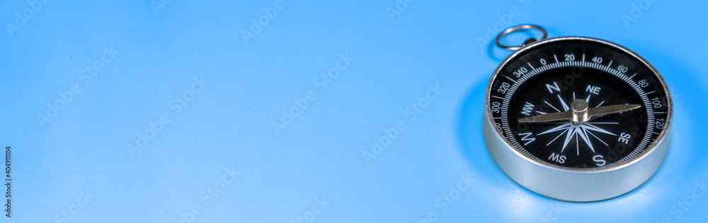 Compass on blue background with copy space. Direction concept. Banner Compass on blue background with copy space. Direction concept. Banner
