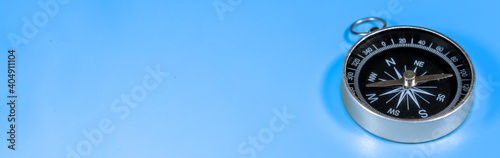 Compass on blue background with copy space. Direction concept. Banner