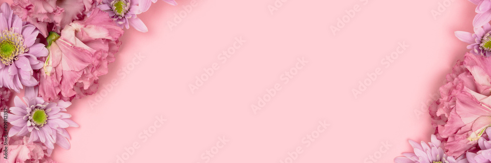 Banner with eustoma and aster flower texture on a pink pastel background. Springtime concept with copyspace. Floral frame.