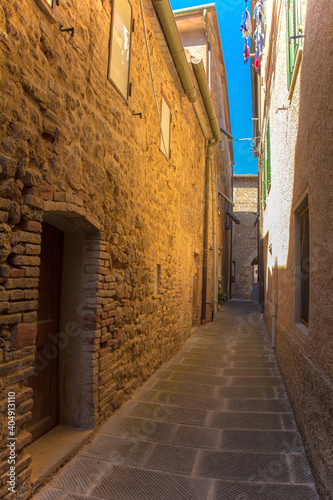 A quiet residential street in the historic medieval village of Batignano  Grosseto Province  Tuscany  Italy 