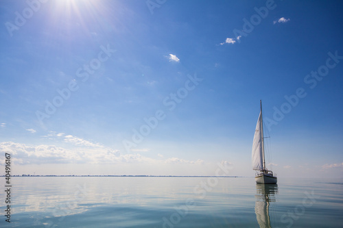 Sailboat calm day with blue sky perfect photo