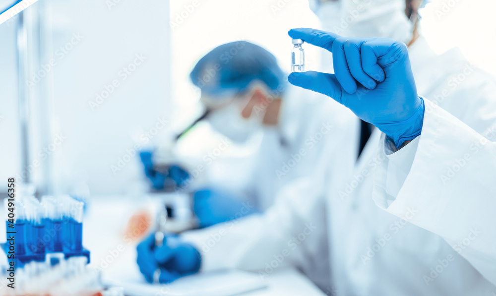 background image of a scientist recording test results in a lab log. background image of a scientist recording test results in a lab log.